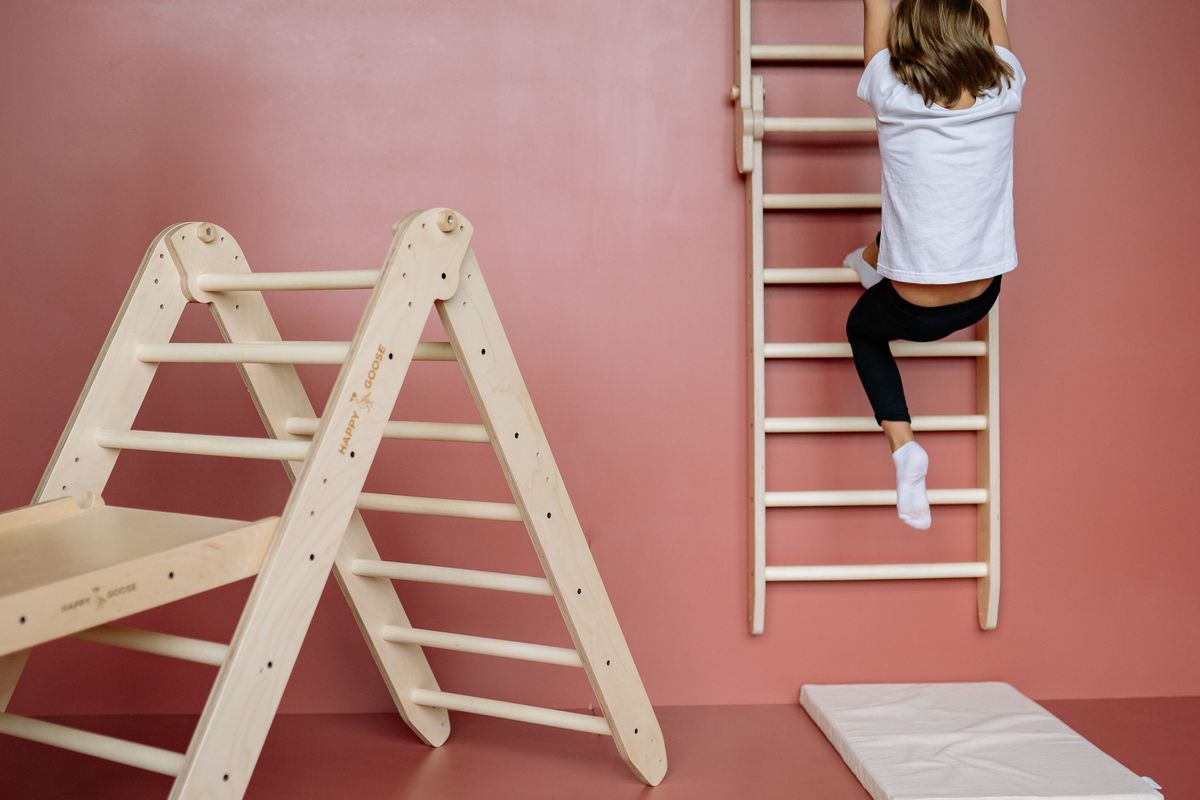 A child climbing on soft foam blocks arranged as a low indoor obstacle course