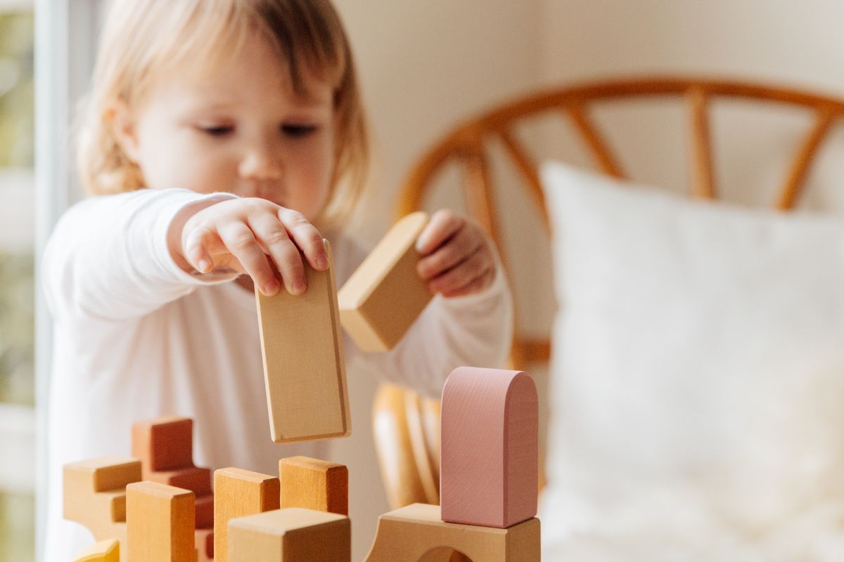 Plain wooden blocks and soft foam shapes set out invitingly on a clean floor